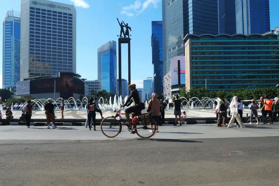 A group of people riding bikes down a street