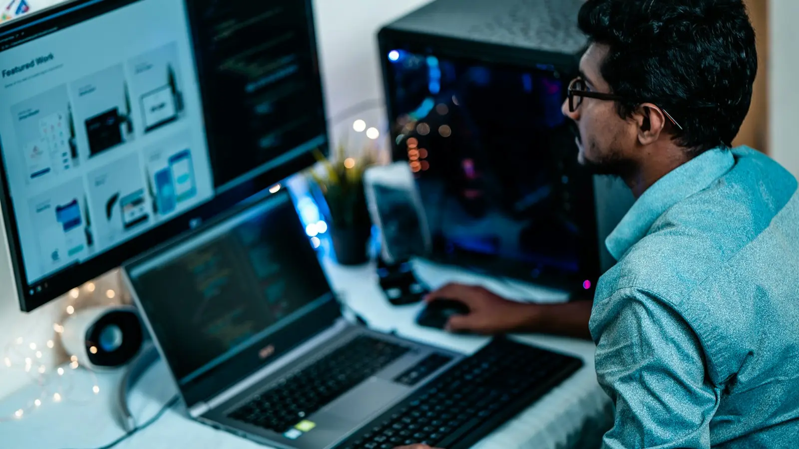 Man in blue dress shirt using computer