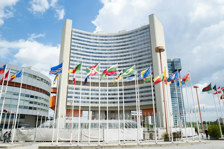 A large building with a lot of flags in front of it
