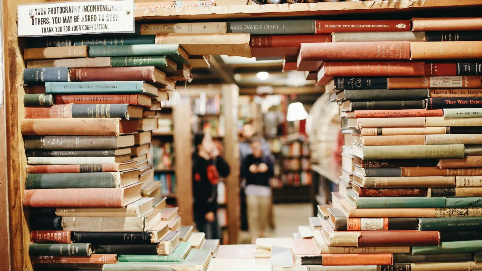 Books on brown wooden shelf