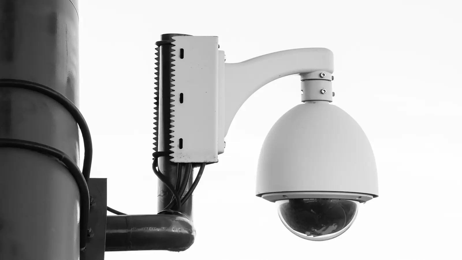 White security camera on post